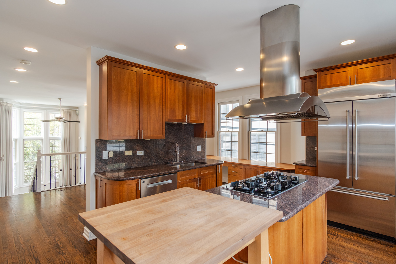 24 North Ada Street, Unit I Chicago, IL 60607 - Photo 10 of 29 a kitchen with stainless steel appliances granite countertop a stove a sink a refrigerator and blue cabinets with wooden floor