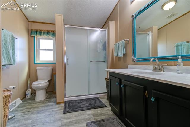 5705 South Yoder Road Yoder, CO 80864 - Photo 26 of 42 update master bathroom off of master bedroom. Shower, flooring, vanity and top updated.