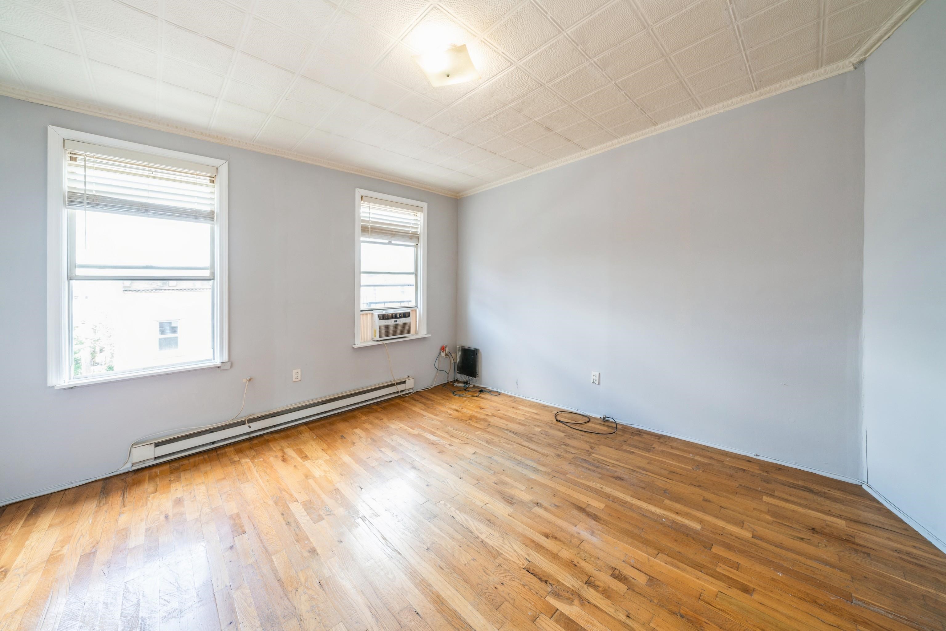 407 4th Street, Unit 4R (6) Hoboken, NJ 07030 - Photo 14 of 17 wooden floor in an empty room with a window