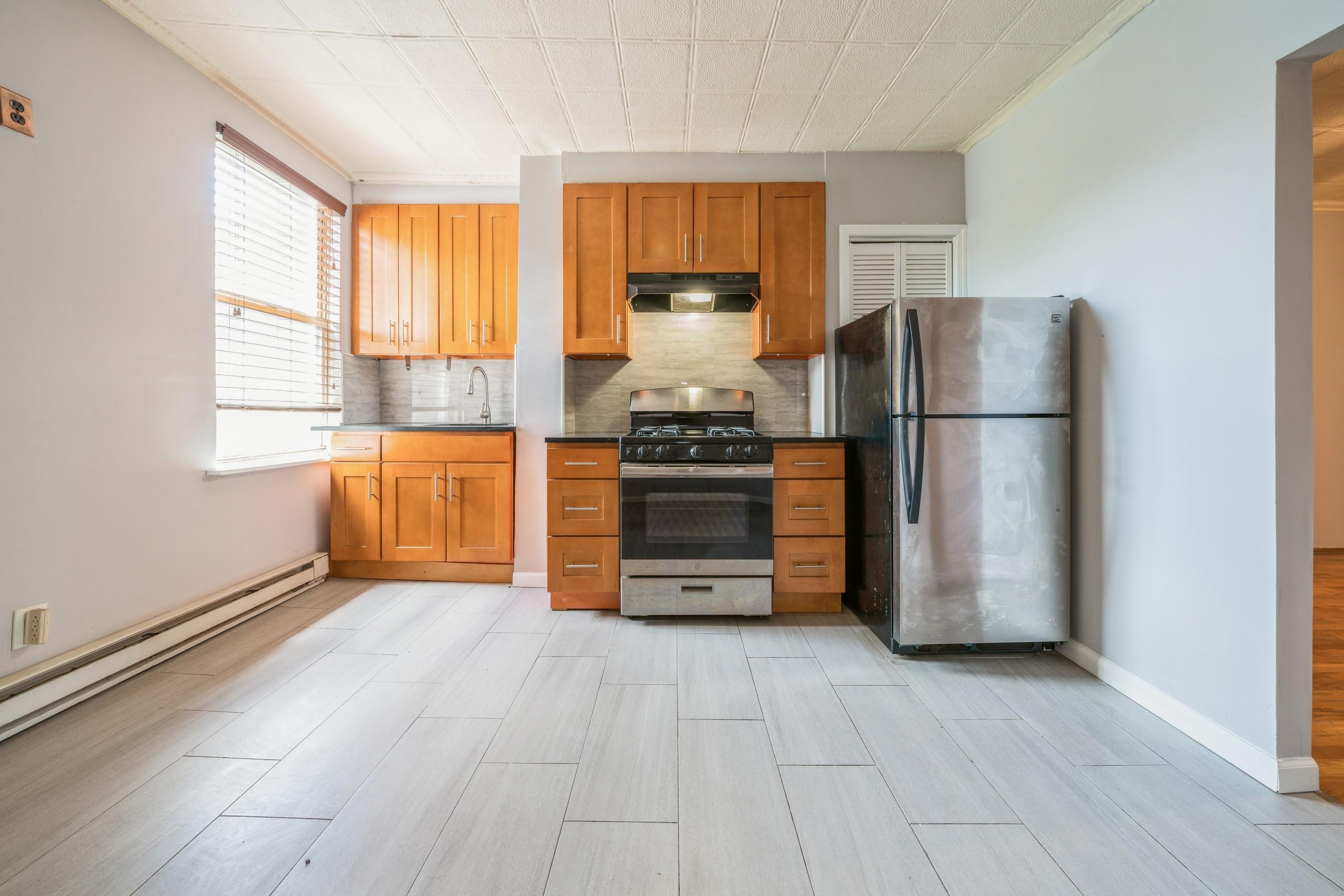 407 4th Street, Unit 4R (6) Hoboken, NJ 07030 - Photo 2 of 17 a kitchen with stainless steel appliances granite countertop a refrigerator and a stove