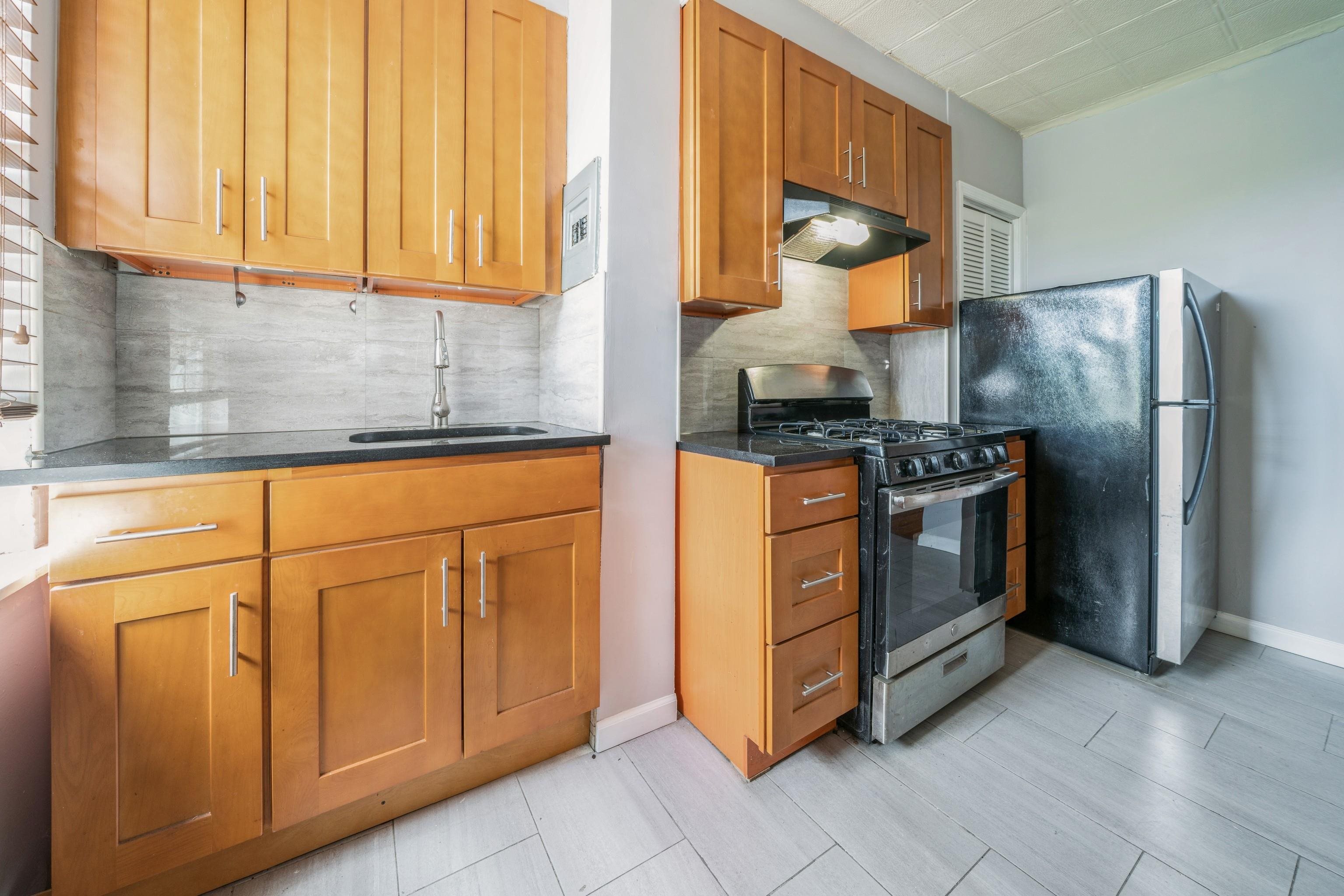 407 4th Street, Unit 4R (6) Hoboken, NJ 07030 - Photo 3 of 17 a kitchen with cabinets and appliances
