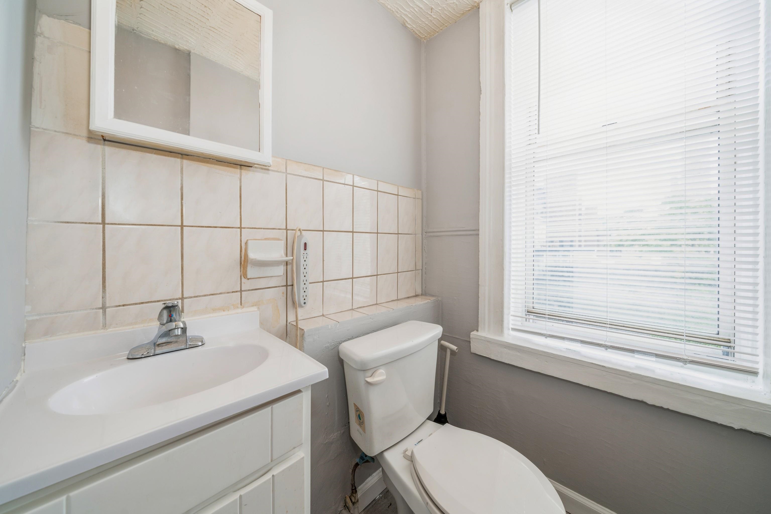 407 4th Street, Unit 4R (6) Hoboken, NJ 07030 - Photo 8 of 17 a bathroom with a sink a toilet and a mirror
