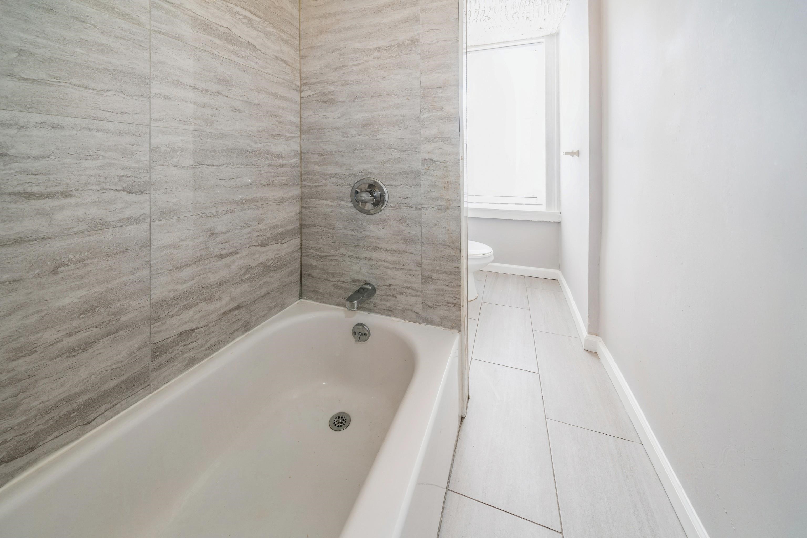 407 4th Street, Unit 4R (6) Hoboken, NJ 07030 - Photo 9 of 17 a bathroom with a bathtub