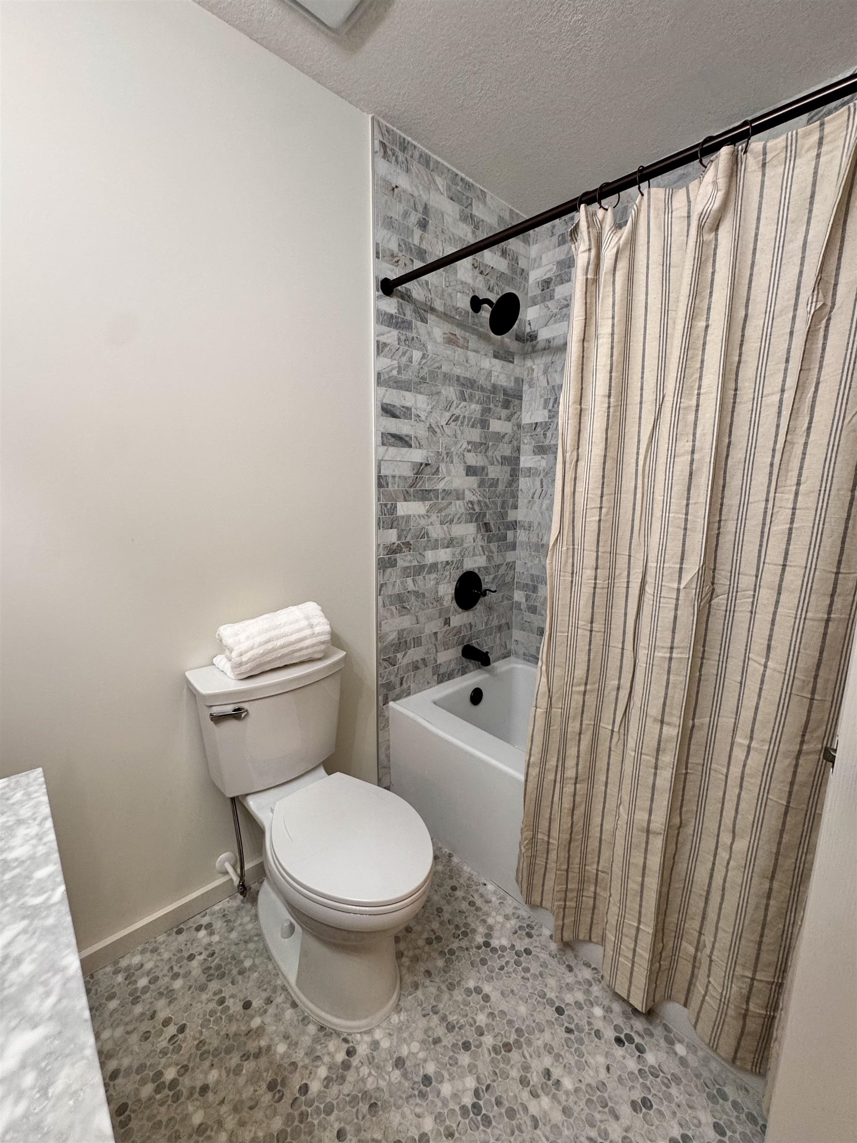 226 Jasmine Road St. Augustine, FL 32086 - Photo 11 of 20 a white toilet sitting next to a shower curtain