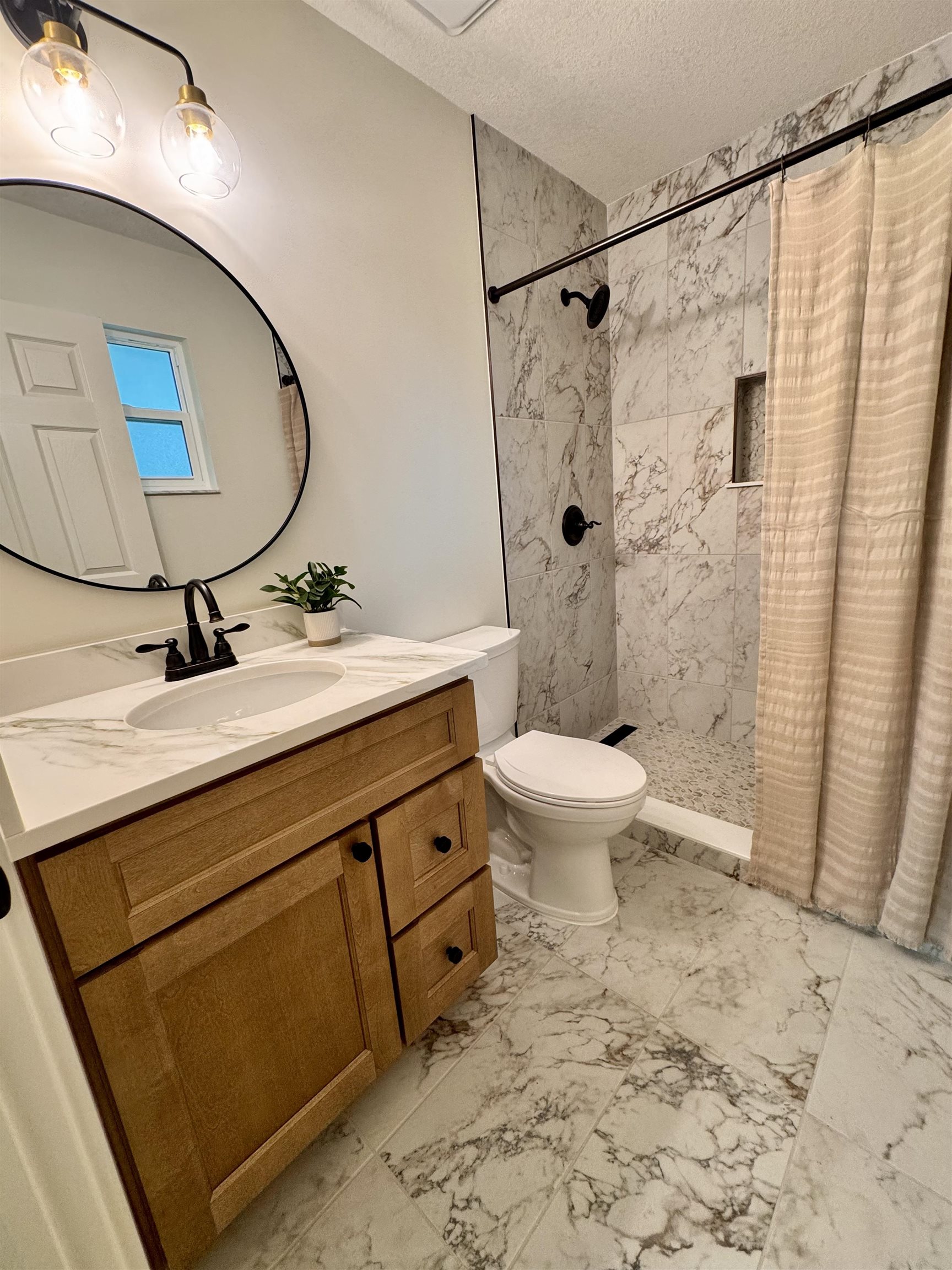 226 Jasmine Road St. Augustine, FL 32086 - Photo 20 of 20 a bathroom with a granite countertop sink toilet a mirror and shower