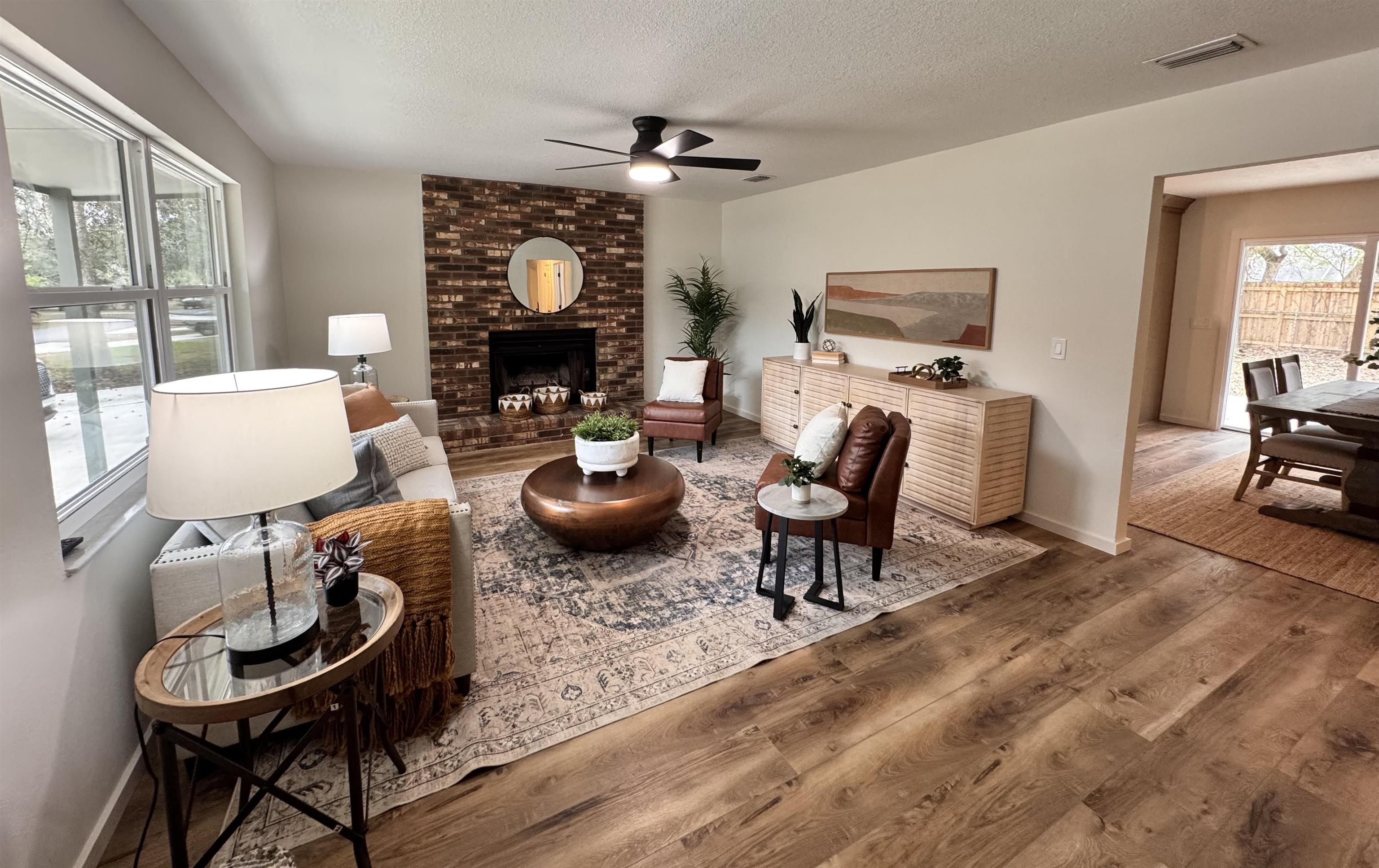 226 Jasmine Road St. Augustine, FL 32086 - Photo 2 of 20 a living room with furniture a fireplace and large windows