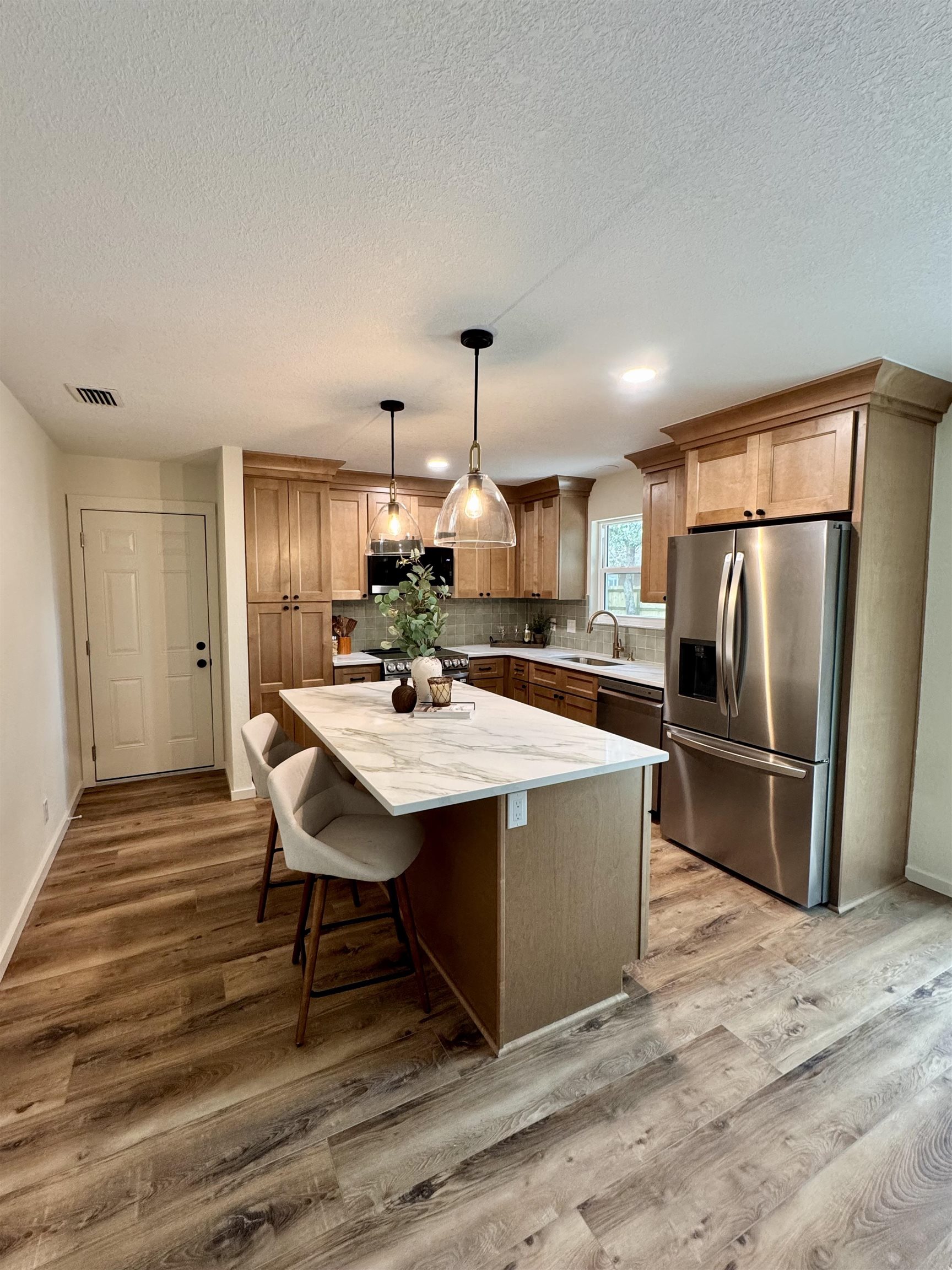 226 Jasmine Road St. Augustine, FL 32086 - Photo 6 of 20 a kitchen with stainless steel appliances a dining table chairs and refrigerator