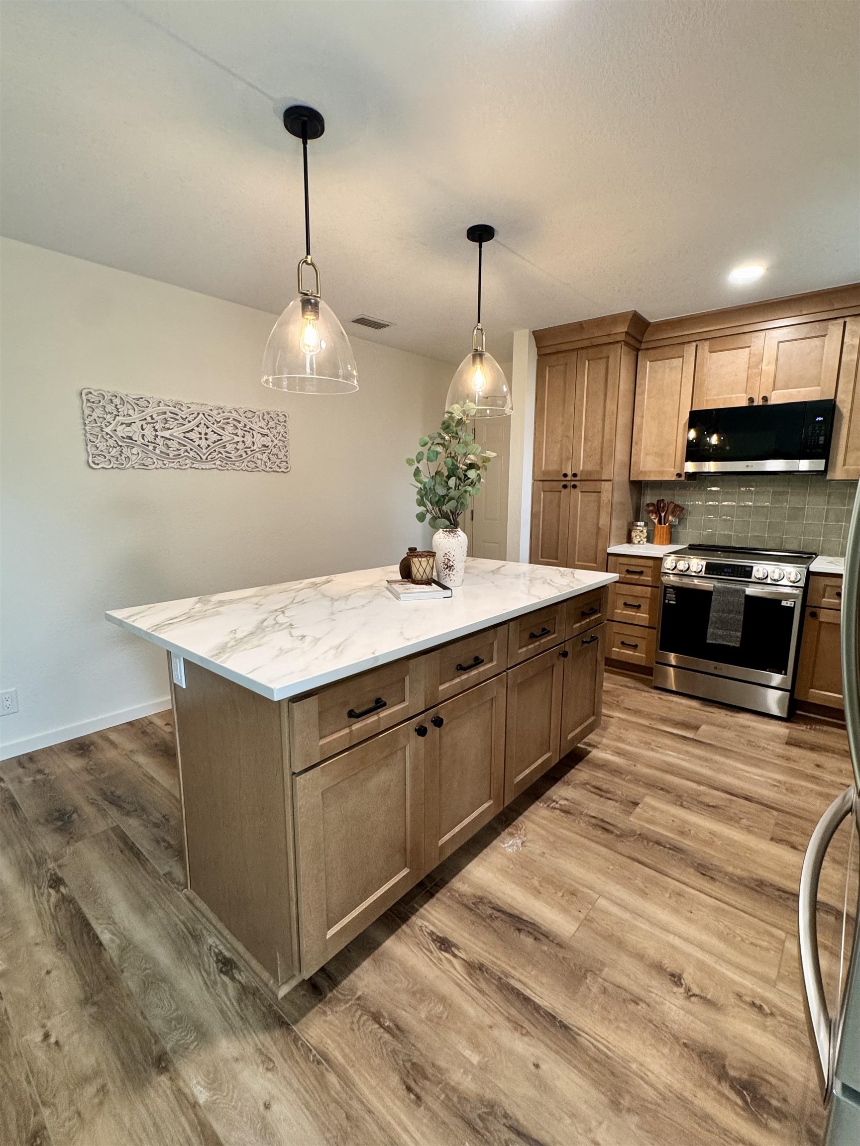 226 Jasmine Road St. Augustine, FL 32086 - Photo 7 of 20 a kitchen with stainless steel appliances granite countertop a sink a stove and a wooden floor