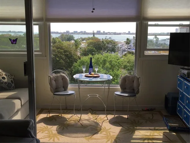 a living room with a large window and a table