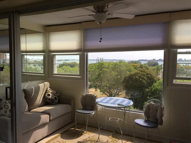 a living room with furniture and a floor to ceiling window