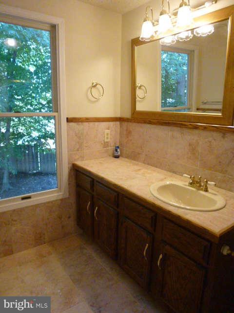 7808 Roundabout Way Springfield, VA 22153 - Photo 14 of 23 a bathroom with a sink and a mirror