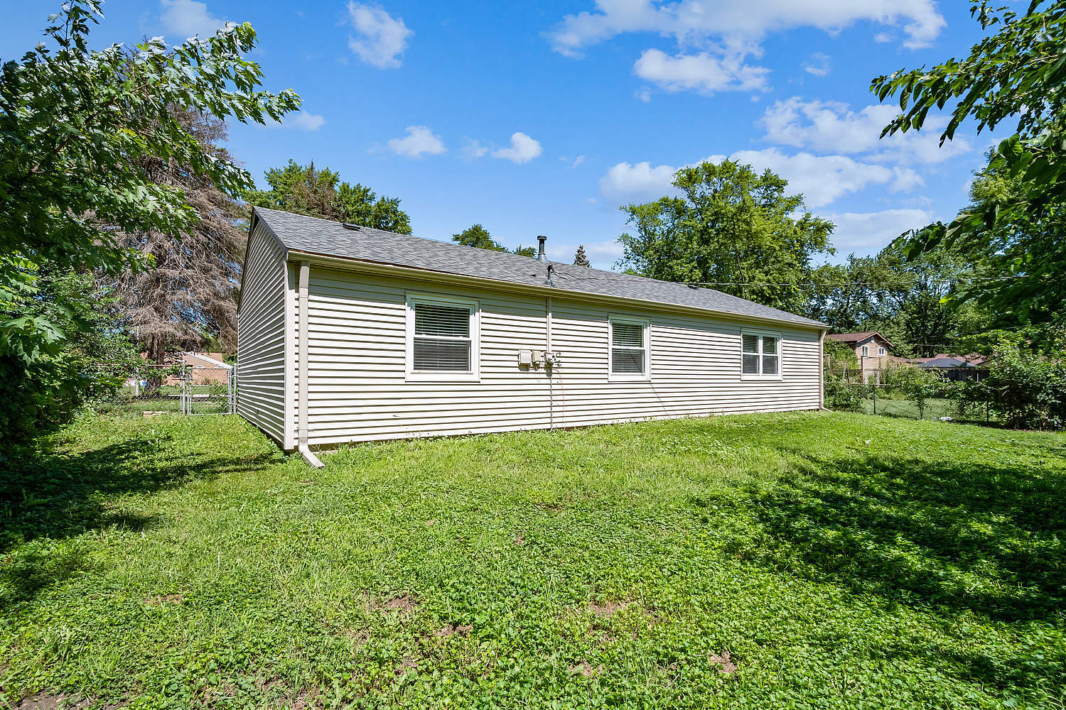 135 Thornhurst Road Bolingbrook, IL 60440 - Photo 3 of 15 a view of a backyard with plants and large tree