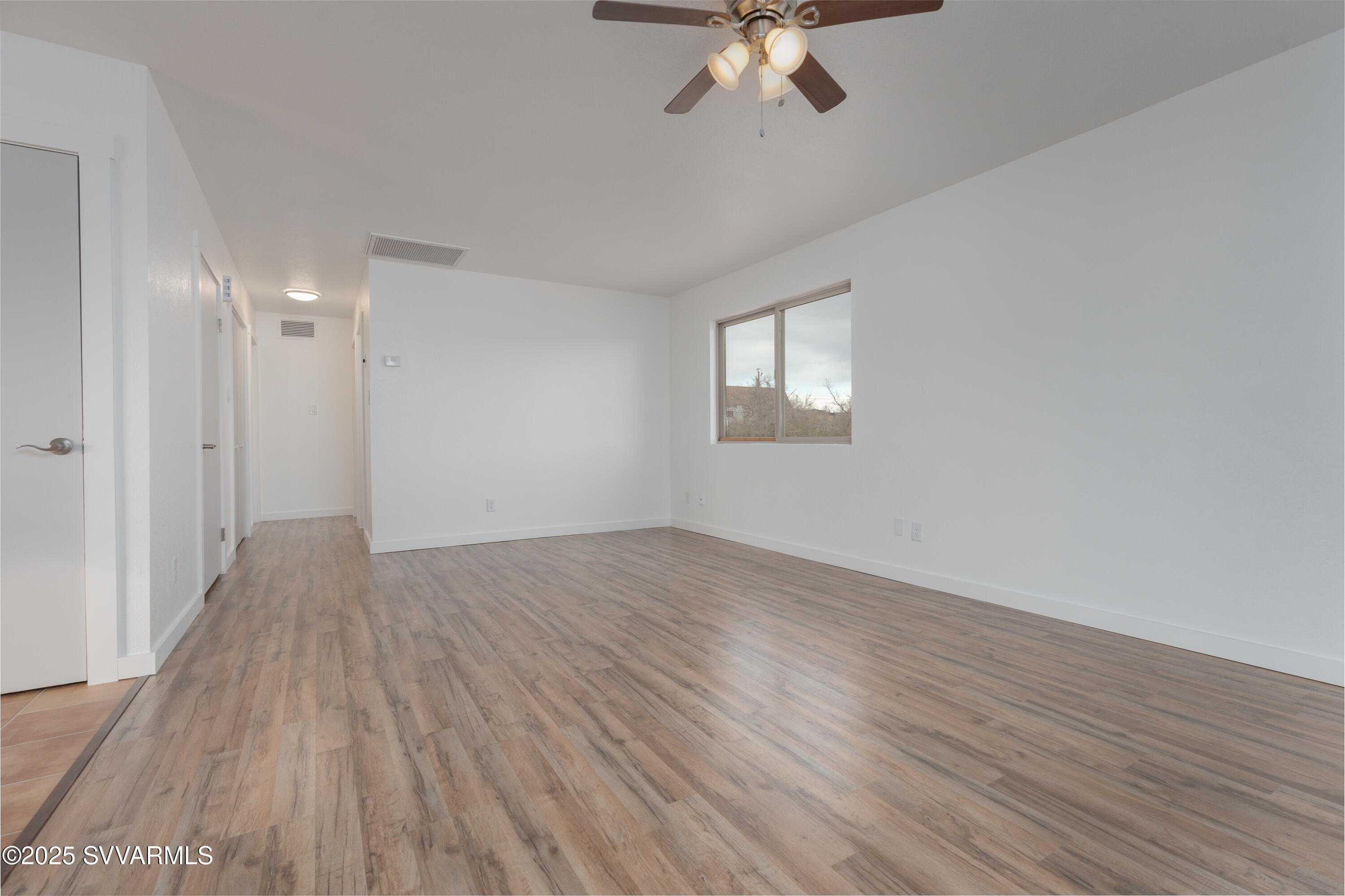 4875 East Mallard Drive Rimrock, AZ 86335 - Photo 15 of 36 a view of an empty room with wooden floor and a window