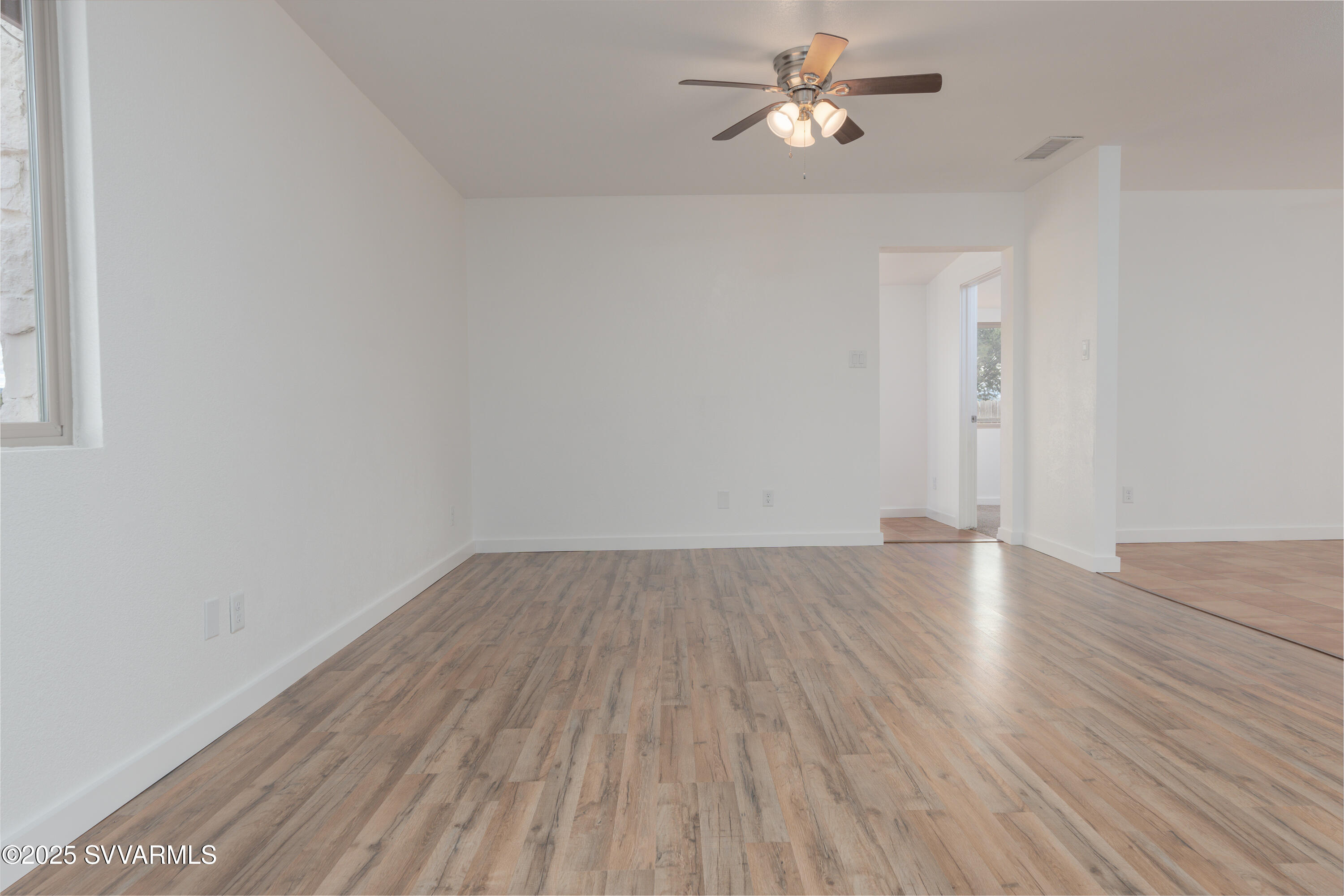 4875 East Mallard Drive Rimrock, AZ 86335 - Photo 16 of 36 an empty room with wooden floor and fan
