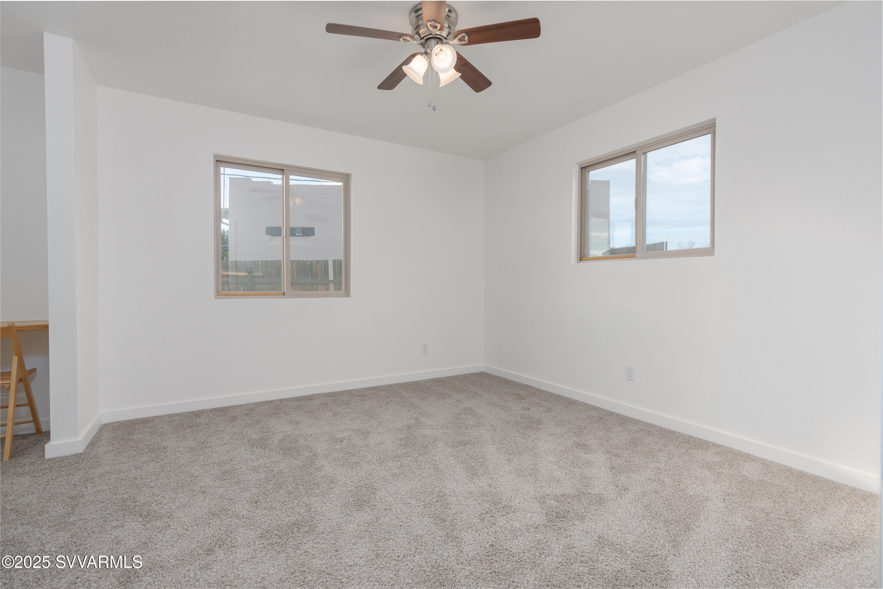 4875 East Mallard Drive Rimrock, AZ 86335 - Photo 24 of 36 an empty room with a window and a ceiling fan
