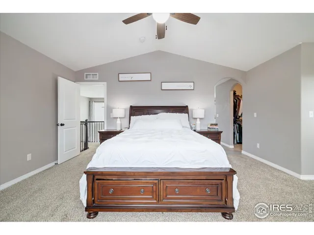 a bedroom with a bed and mirror