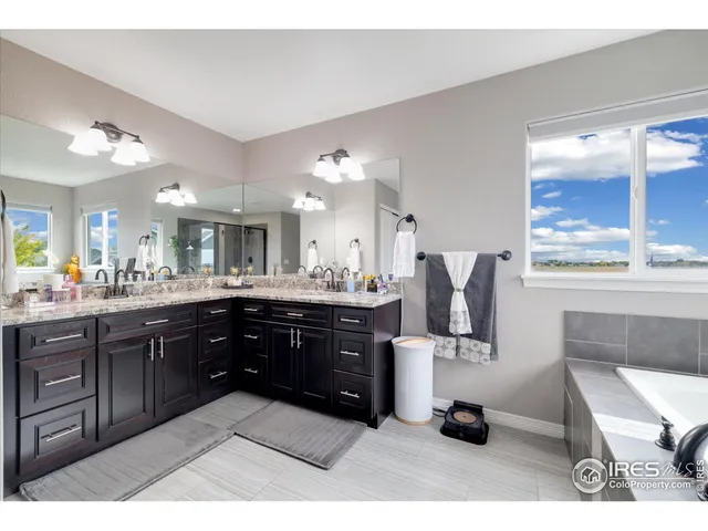 a kitchen with stainless steel appliances kitchen island granite countertop a refrigerator and a sink
