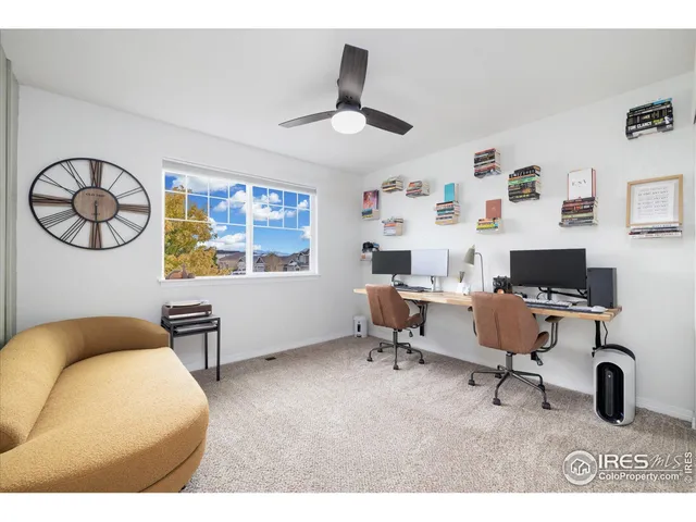 a workspace with furniture window and a ceiling fan