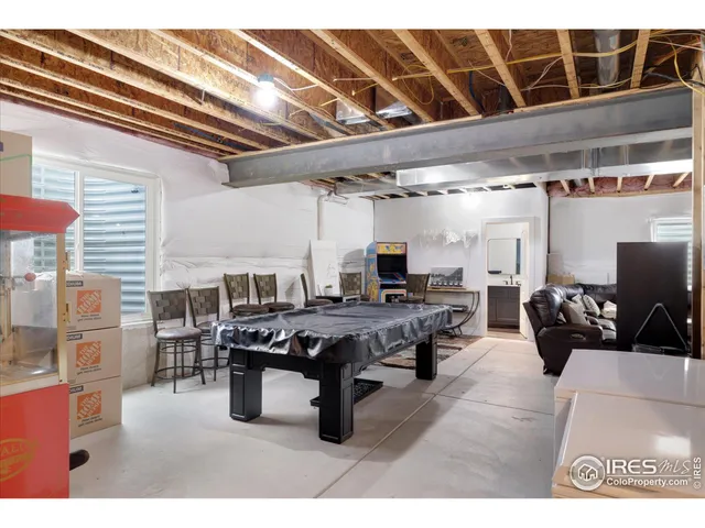 a living room with lots of furniture and clutter