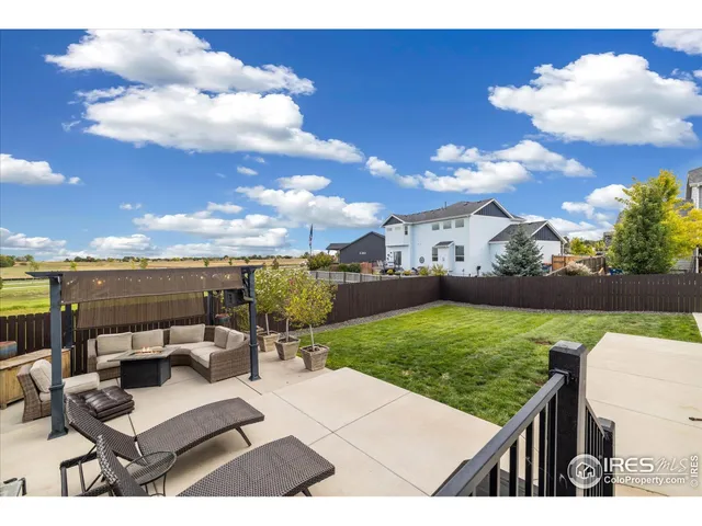 a view of a terrace with a table and chairs