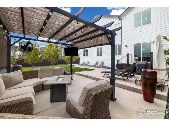 a living room with furniture and a view of kitchen