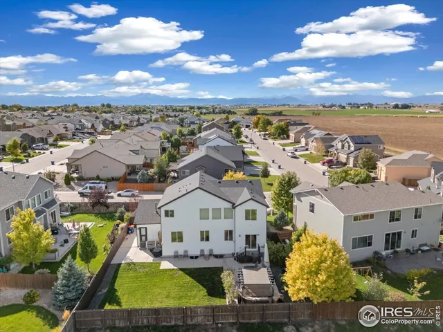 a view of a city with lawn chairs and large tree