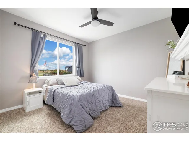 a bedroom with a bed and a desk