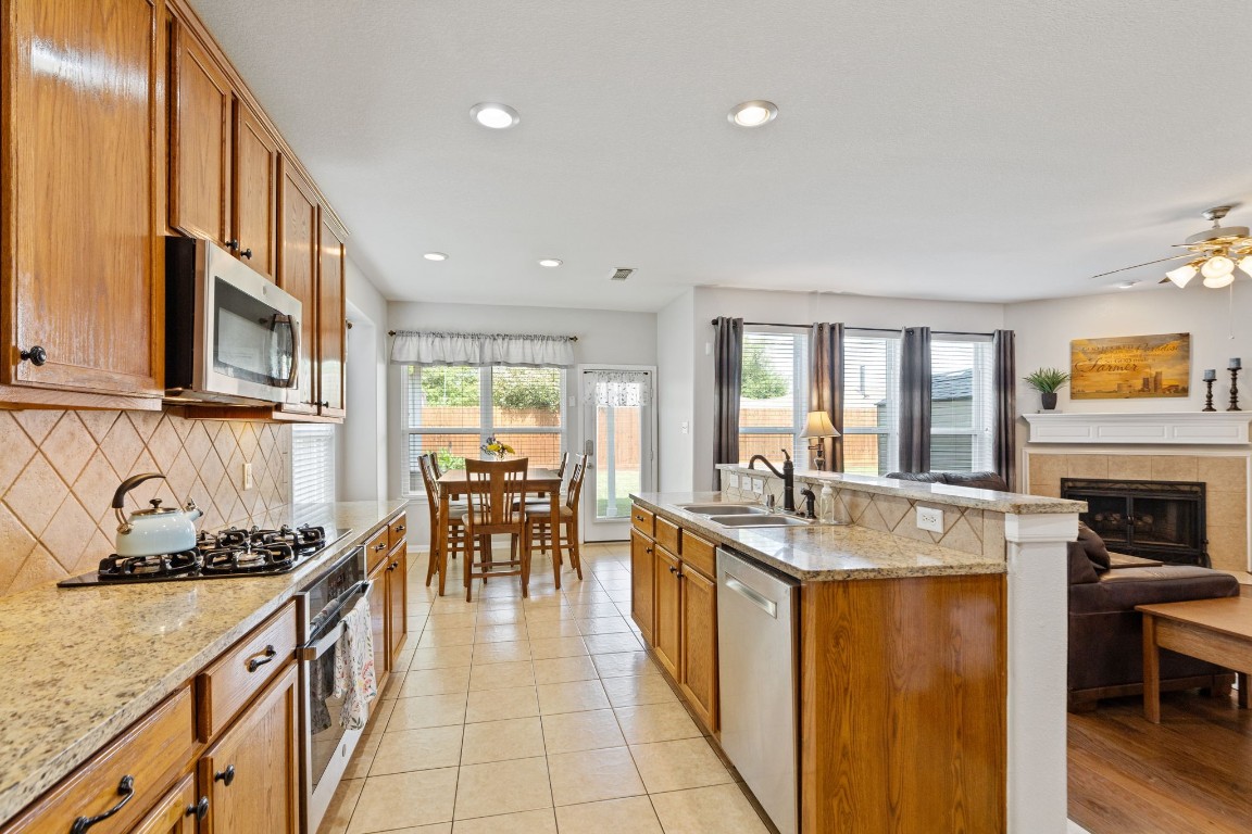 5318 Wisteria Brook Lane Spring, TX 77379 - Photo 16 of 50 a kitchen with sink stove and cabinets