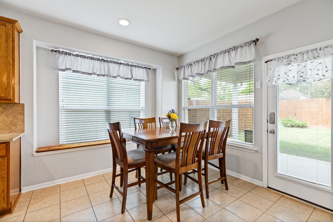 5318 Wisteria Brook Lane Spring, TX 77379 - Photo 18 of 50 a view of a dining room with furniture large windows and wooden floor