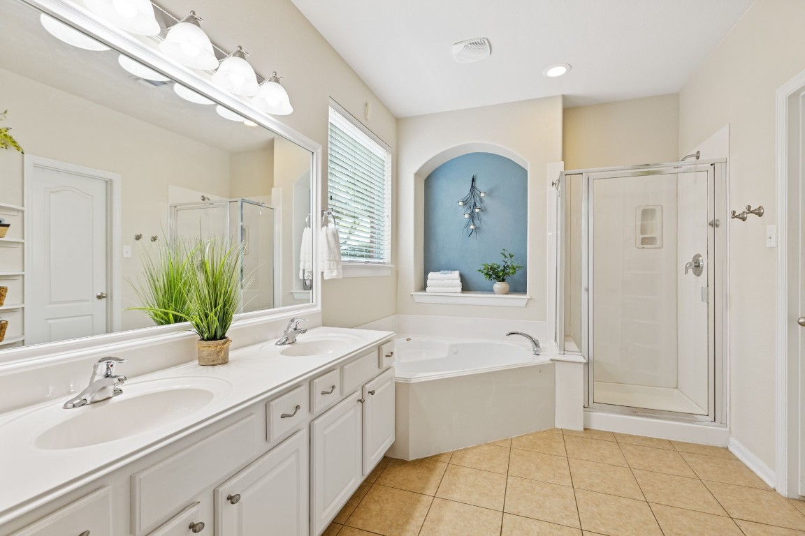 5318 Wisteria Brook Lane Spring, TX 77379 - Photo 22 of 50 a spacious bathroom with a double vanity sink a mirror and a bathtub