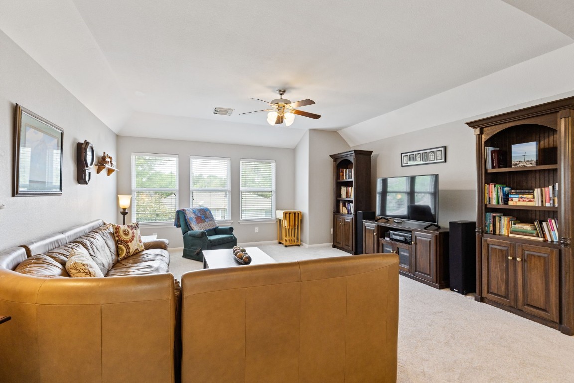 5318 Wisteria Brook Lane Spring, TX 77379 - Photo 25 of 50 a living room with furniture and a flat screen tv