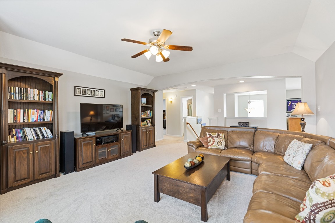 5318 Wisteria Brook Lane Spring, TX 77379 - Photo 26 of 50 a living room with furniture a ceiling fan and a flat screen tv