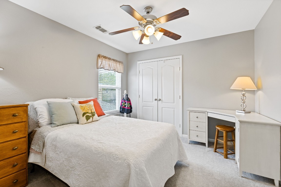 5318 Wisteria Brook Lane Spring, TX 77379 - Photo 29 of 50 a bedroom with a bed and a chandelier