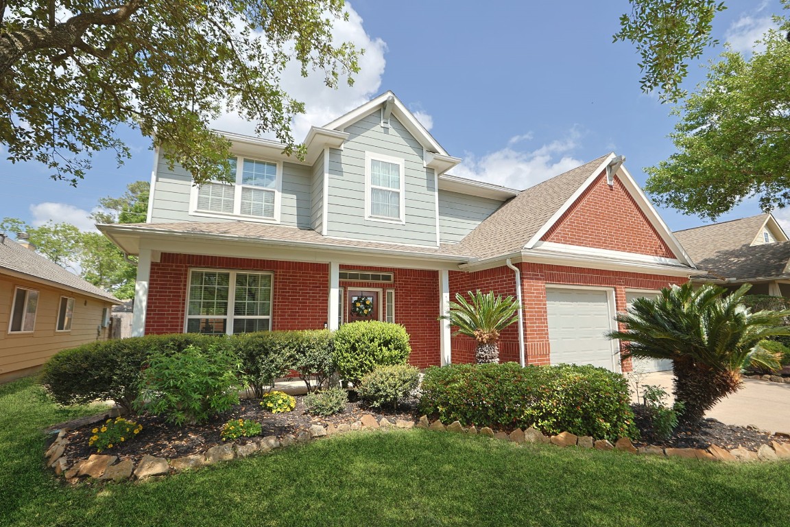 5318 Wisteria Brook Lane Spring, TX 77379 - Photo 3 of 50 a front view of a house with a yard and potted plants