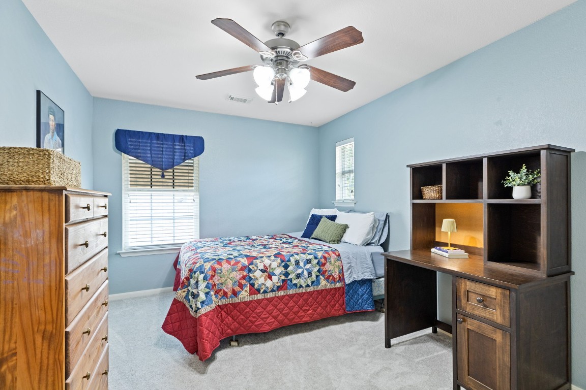 5318 Wisteria Brook Lane Spring, TX 77379 - Photo 30 of 50 a bedroom with a bed and a flat screen tv