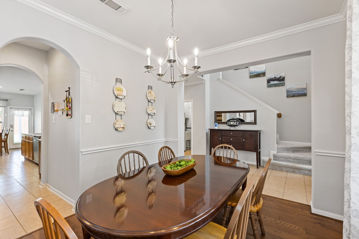 5318 Wisteria Brook Lane Spring, TX 77379 - Photo 10 of 50 a view of a dining room with furniture a chandelier and wooden floor