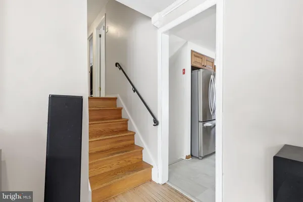 a view of entryway and hall with wooden floor