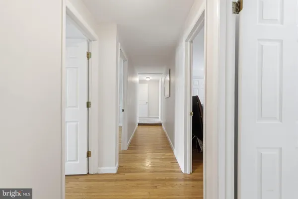 a view of a hallway with wooden floor