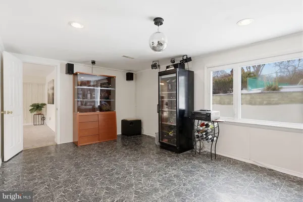 a view of an empty room with window and cabinet