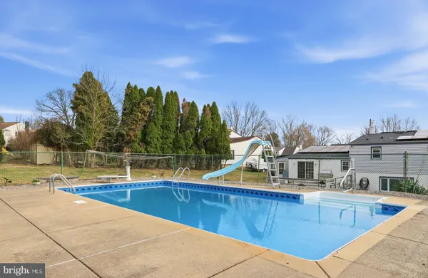 a view of a house with swimming pool and sitting area