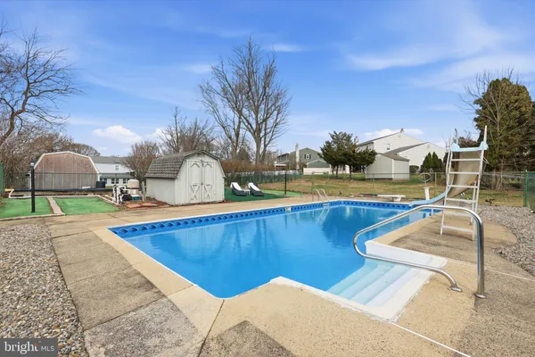a view of a swimming pool with an outdoor seating