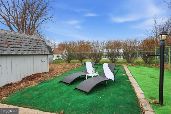 a view of a garden with lawn chairs