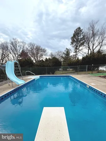 a view of a swimming pool with an outdoor seating
