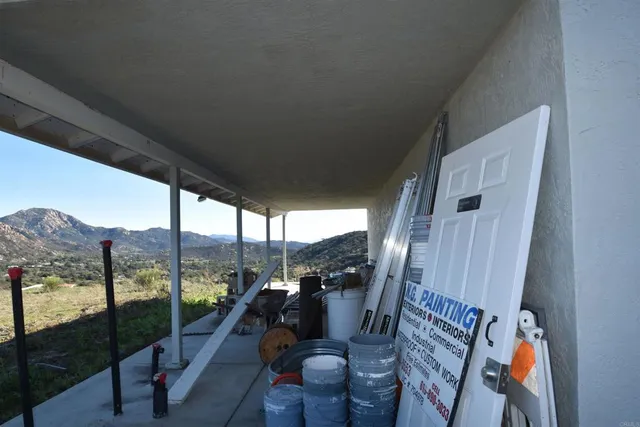 a view of a living room with furniture and floor to ceiling window