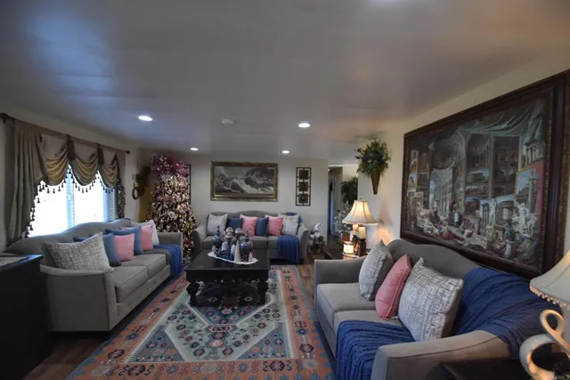 a living room with furniture a large window and a flat screen tv