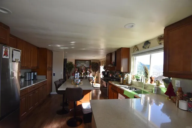 a kitchen with stainless steel appliances granite countertop sink stove top oven and cabinets