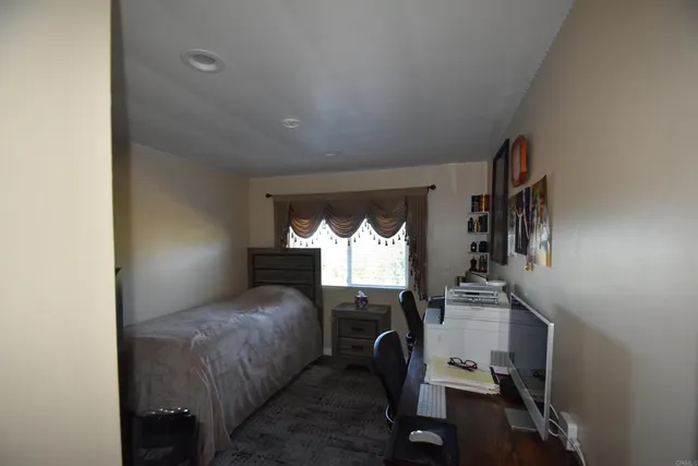 a bedroom with furniture and a window