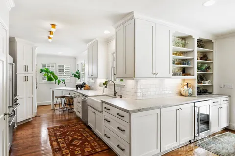 a kitchen with a sink stove and cabinets