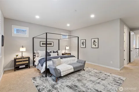 a bedroom with furniture and a rug