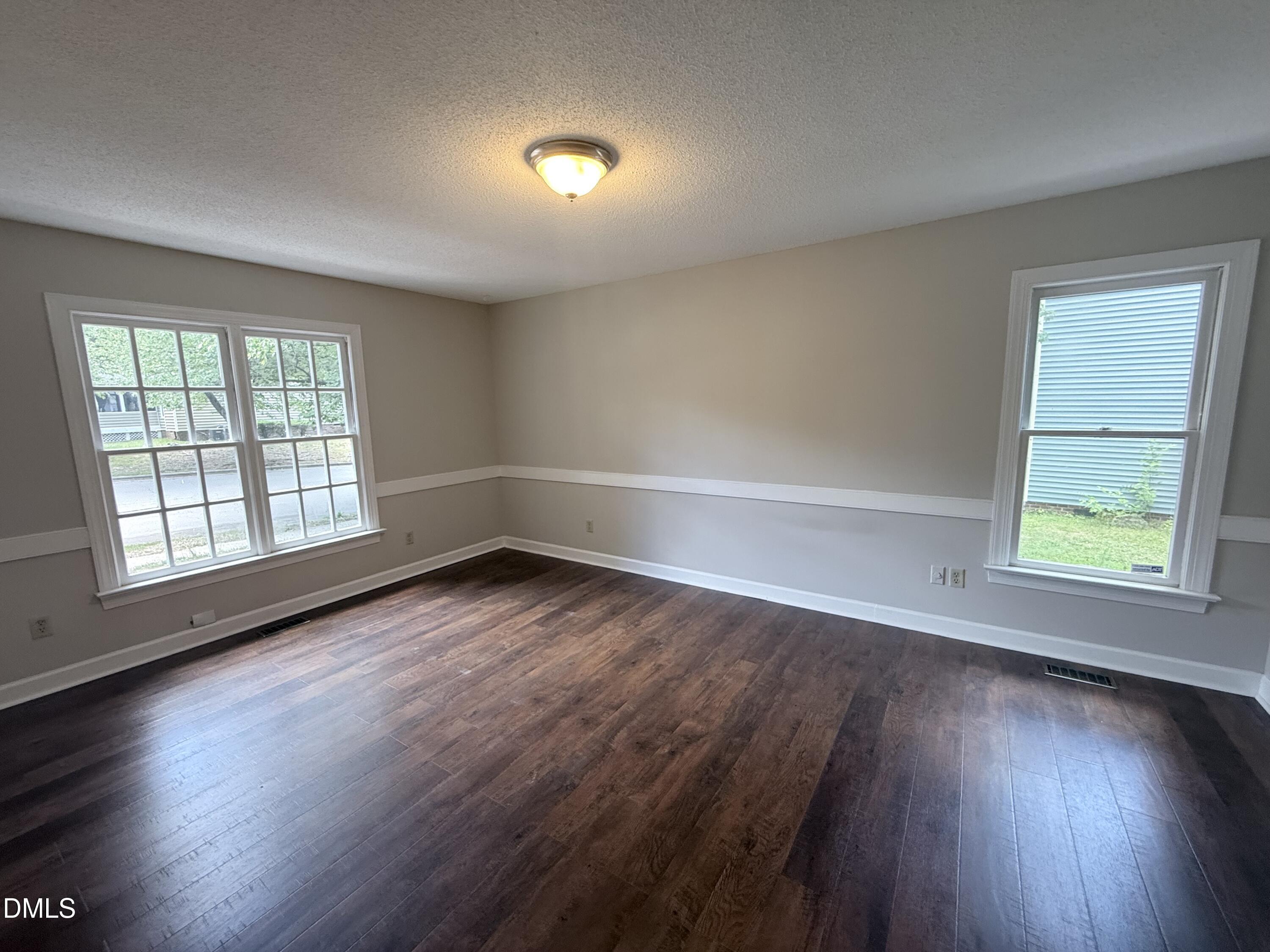 2900 Broadlands Drive Raleigh, NC 27604 - Photo 33 of 60 an empty room with wooden floor and windows